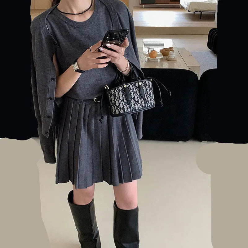 Grey knitted two-piece set with 3D pattern, featuring a belted vest skirt and long-sleeve cardigan.