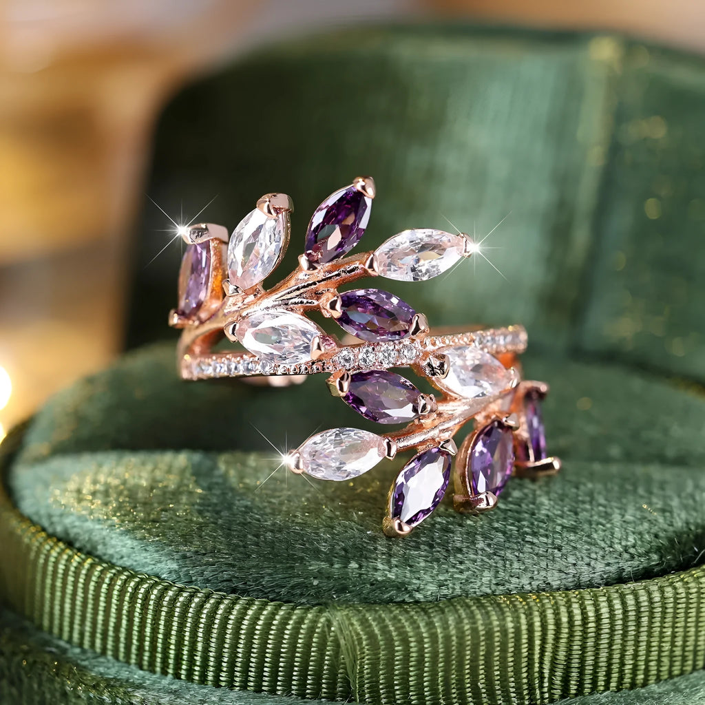 Adjustable copper leaf fashion ring with a central zircon stone on a model's hand, showing rose gold and platinum colour variants.