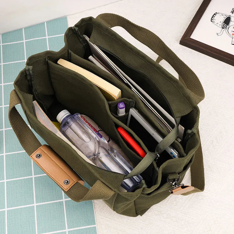 Canvas tote bag with internal organisation pockets for phone, documents, laptop, and camera in horizontal square shape