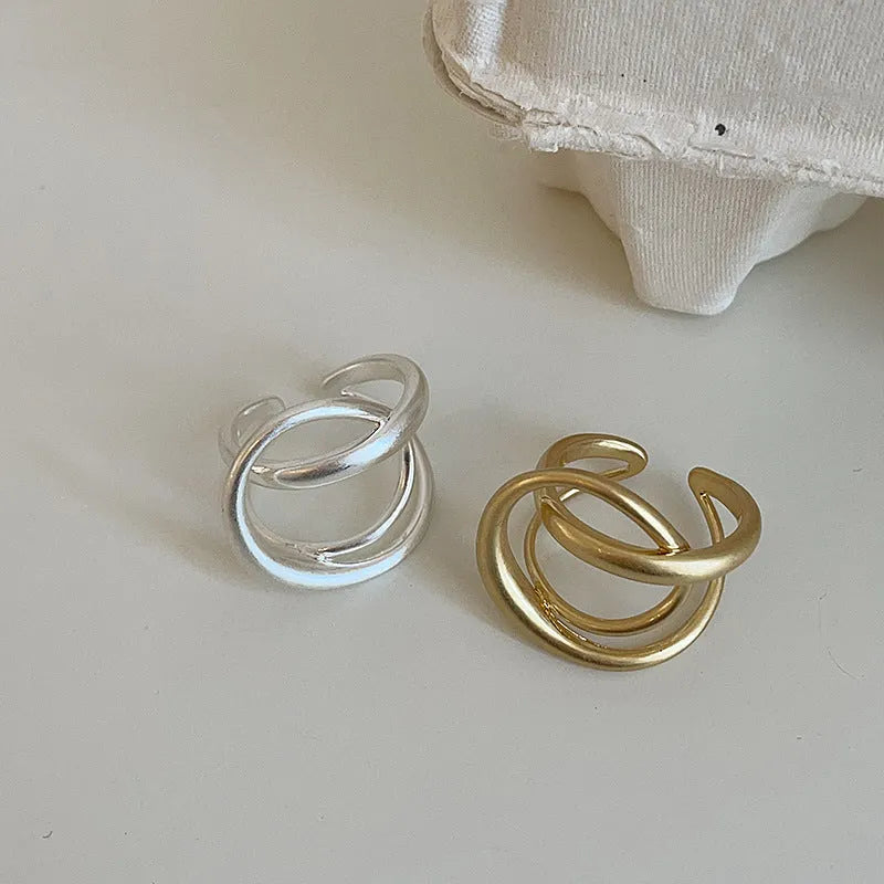 Geometric open ring with interlaced matte metal construction in gold and silver plating options