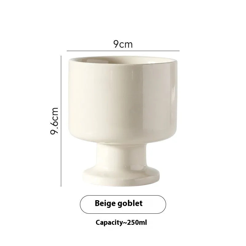 Hand-pinched irregular shaped ceramic mug in a solid colour on a plain background.