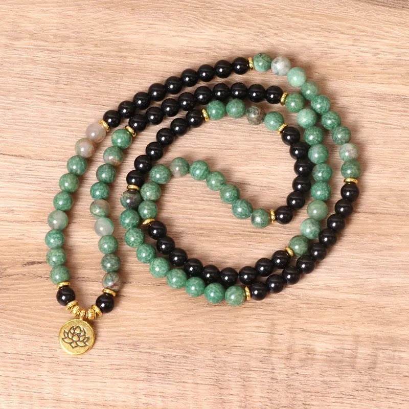 Green and black alloy elastic beaded long bracelet on a wrist, showing natural style design.