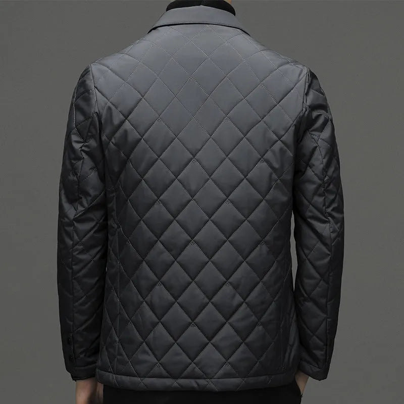 Man wearing a solid colour thick lapel down jacket with side seam pockets.