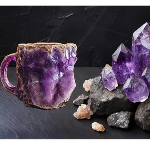 A purple resin coffee mug with a handle, showing a crystal-like structure, on a table.