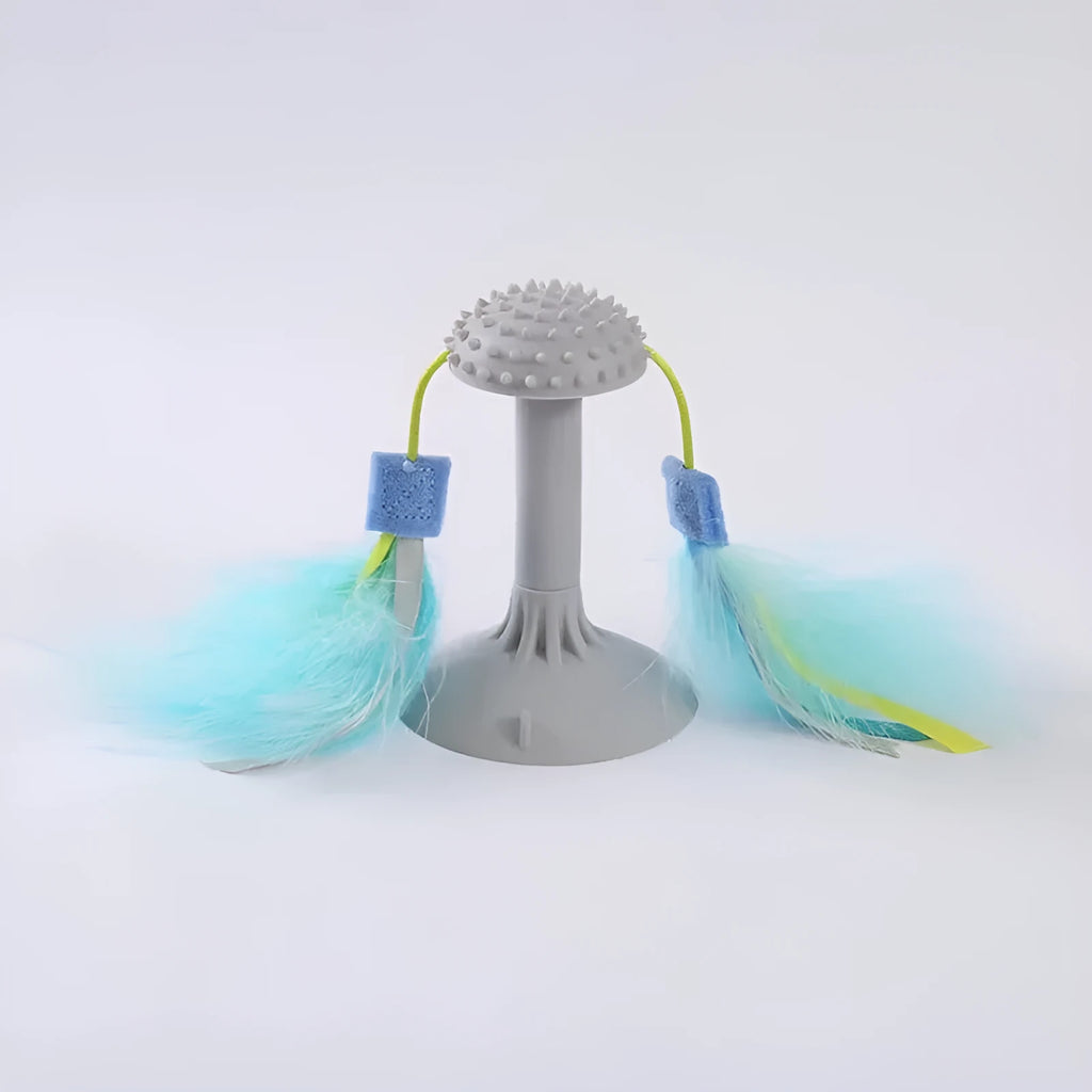 Blue cat toy wand with double haired prick head and suction cup base on a window