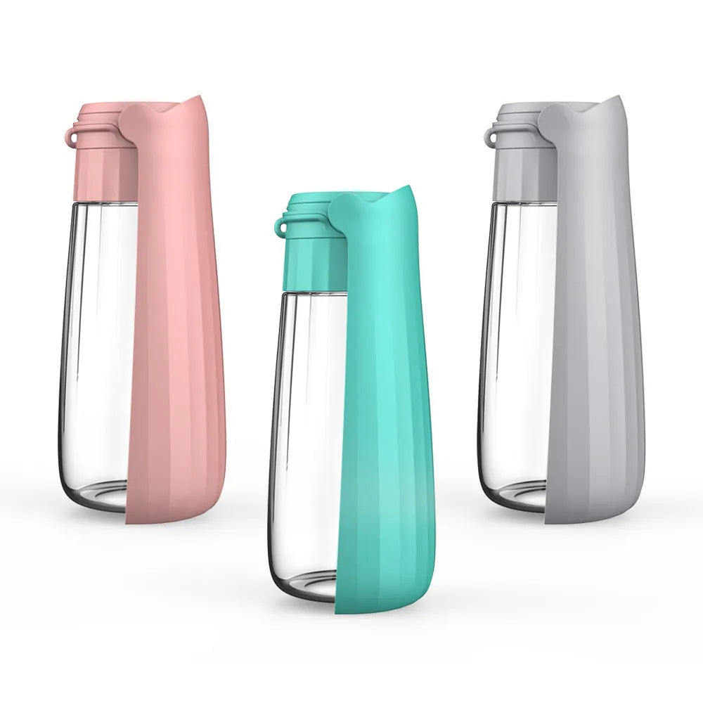 Portable folding dog water bottle 550ml in Lake Blue, with cup top, on outdoor background