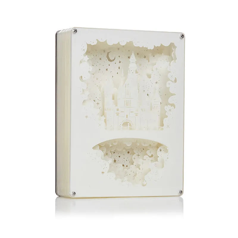 Modern white USB night light with a three-dimensional carved pattern and remote control on a wooden bedside table.