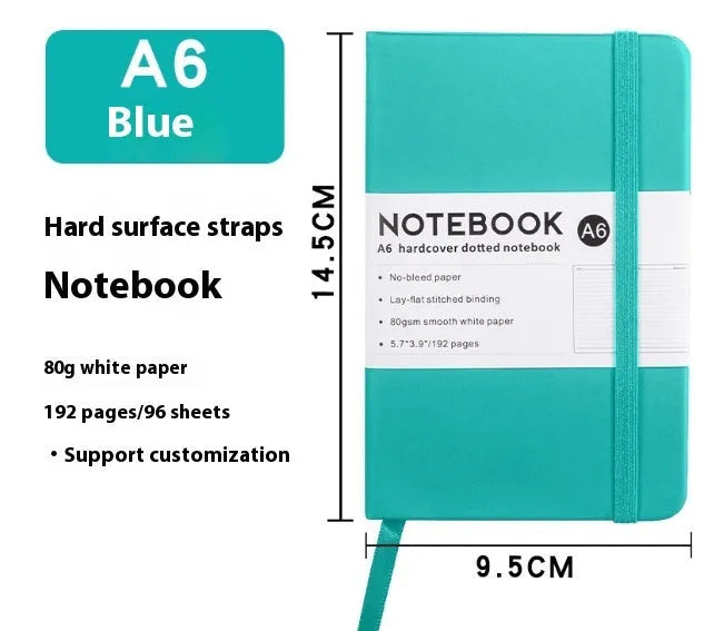 A5 size notebook with soft skin-feel PU leather cover and strap closure, open to show horizontal lined pages.