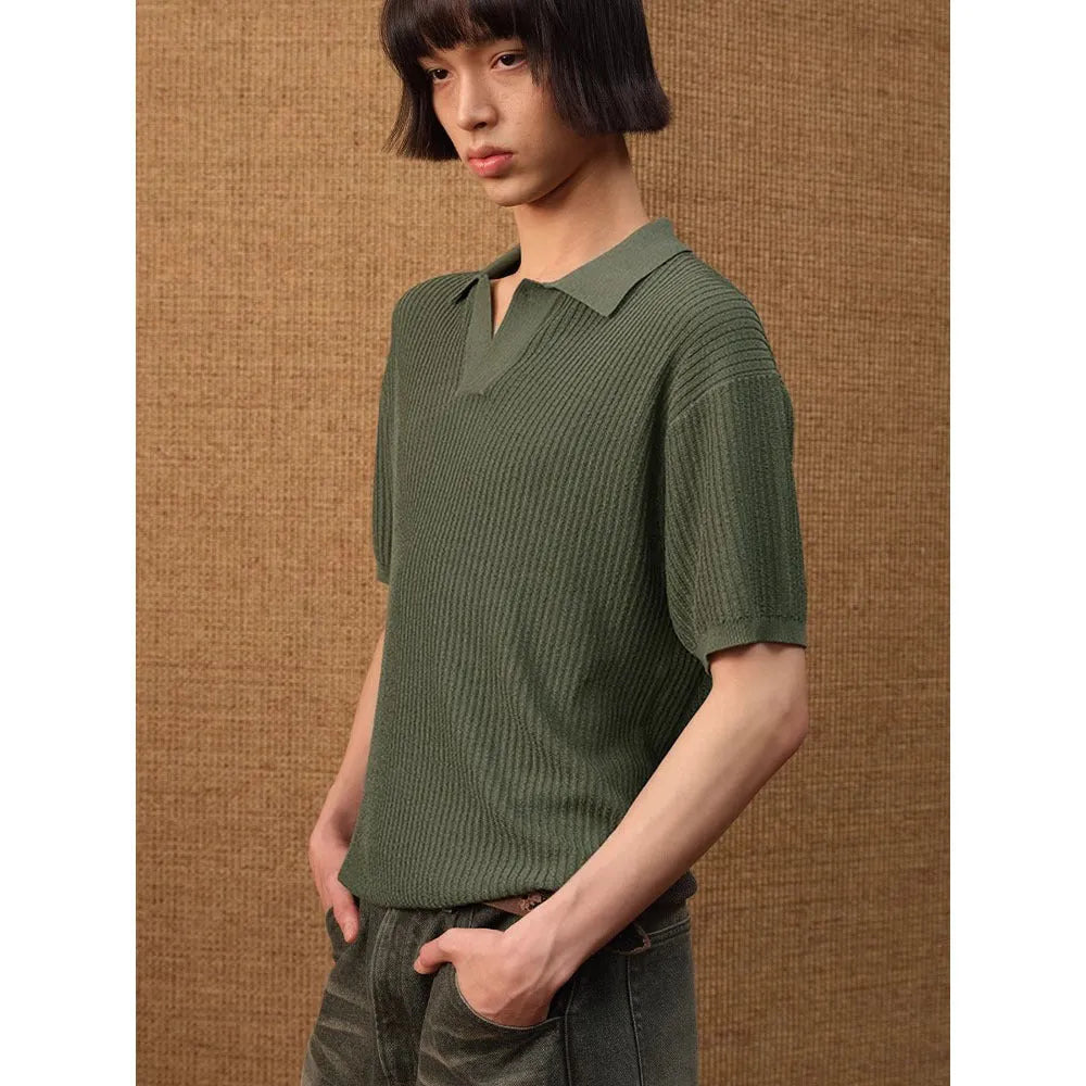 Man wearing a creamy white striped loose fit short sleeve polo shirt made from ice silk fabric.
