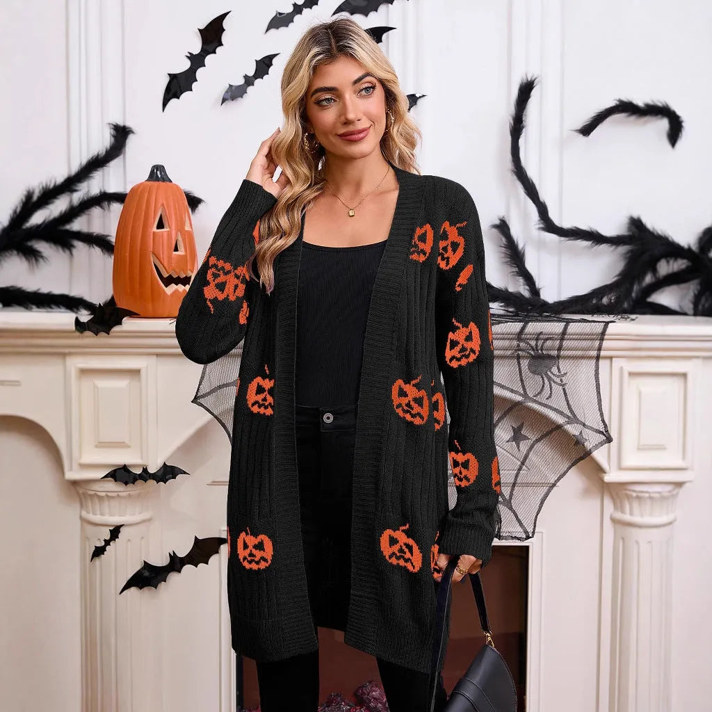 Women's black cardigan with orange knitted pumpkin head jacquard pattern.