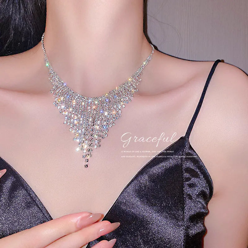 Silver diamond tassel necklace with geometric alloy pendant and ball bead chain on a light background