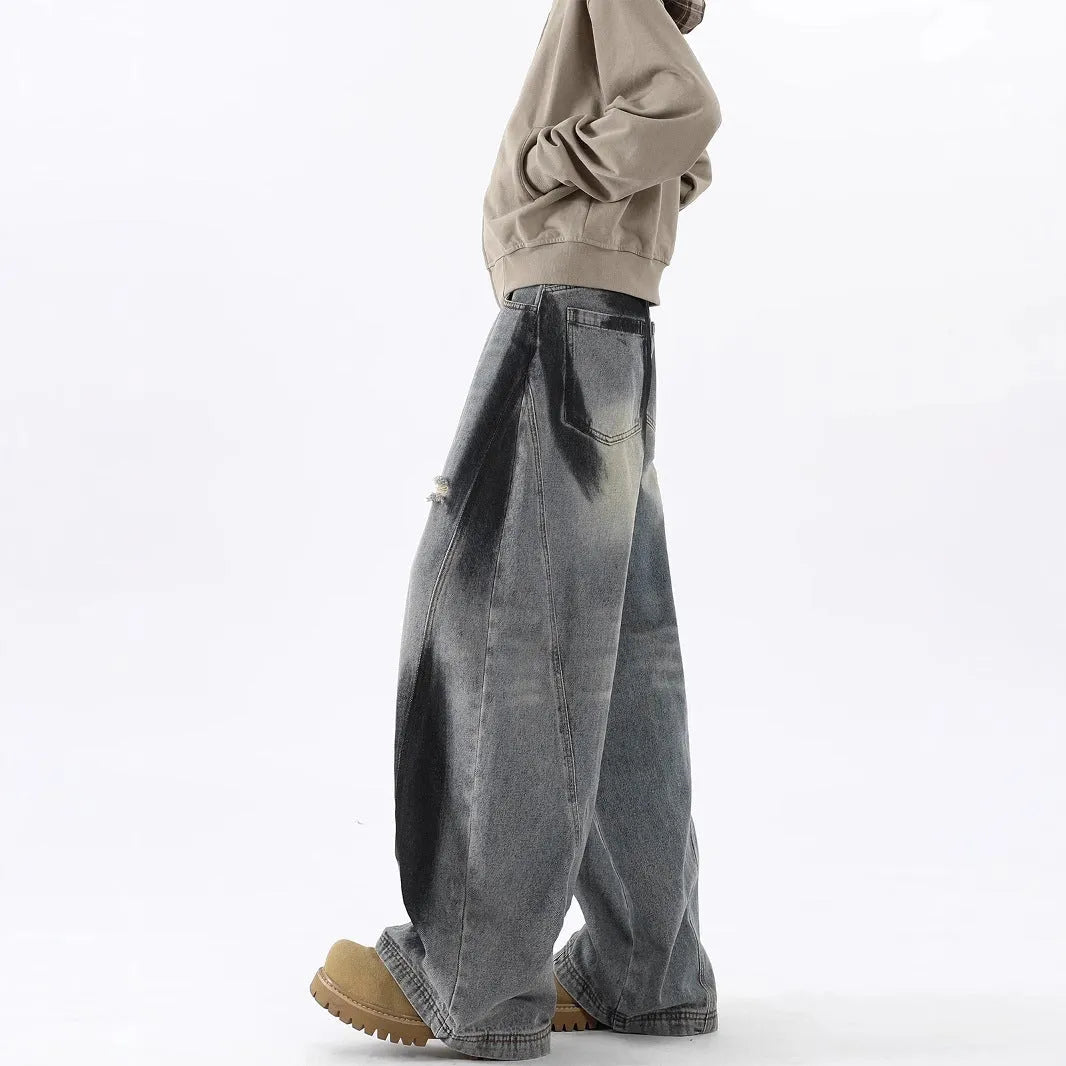 Men's blue distressed jeans with splash-ink patterns and rips in loose fit American style