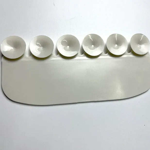 White PVC urine blocking board for children's toilet training placed on standard toilet seat
