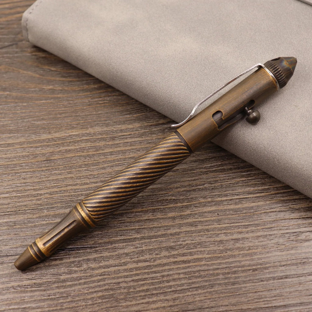 Brass bolt-action tactical pen with cylindrical barrel and press mechanism in retro finish
