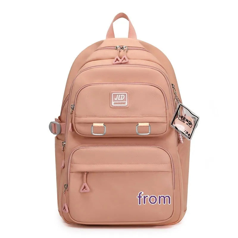 Girls' large nylon backpack in a solid colour showing curved back panel and front pocket.