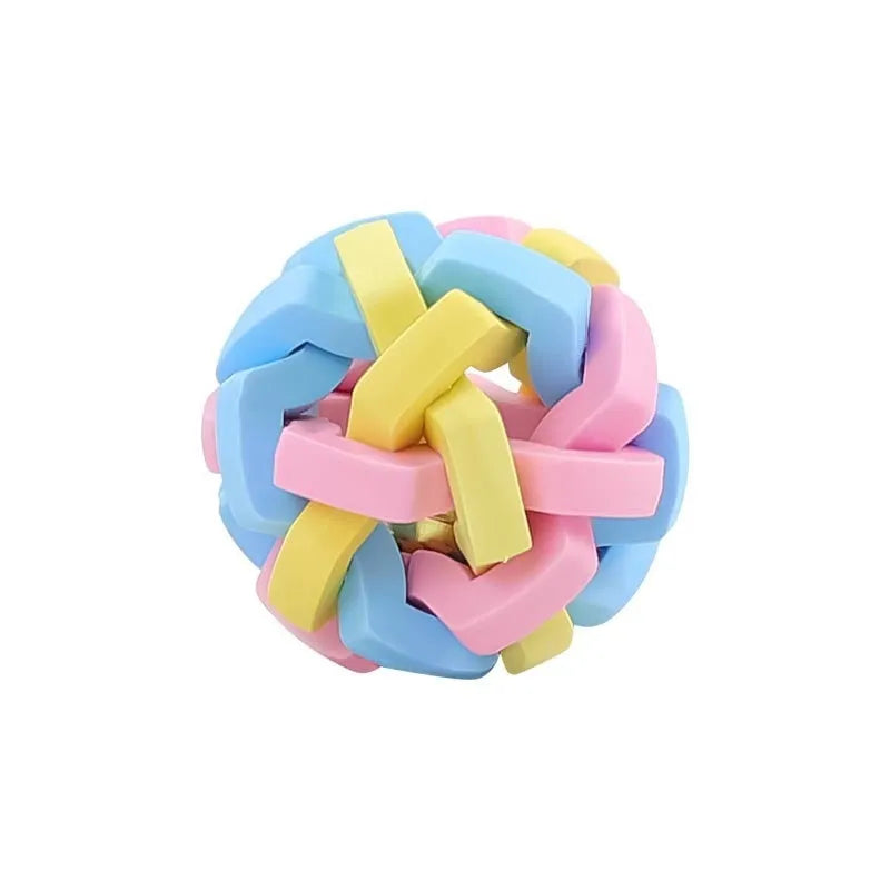 Colourful woven plastic pet toy ball with bell in rainbow colour on white background