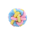 Colourful woven plastic pet toy ball with bell in rainbow colour on white background