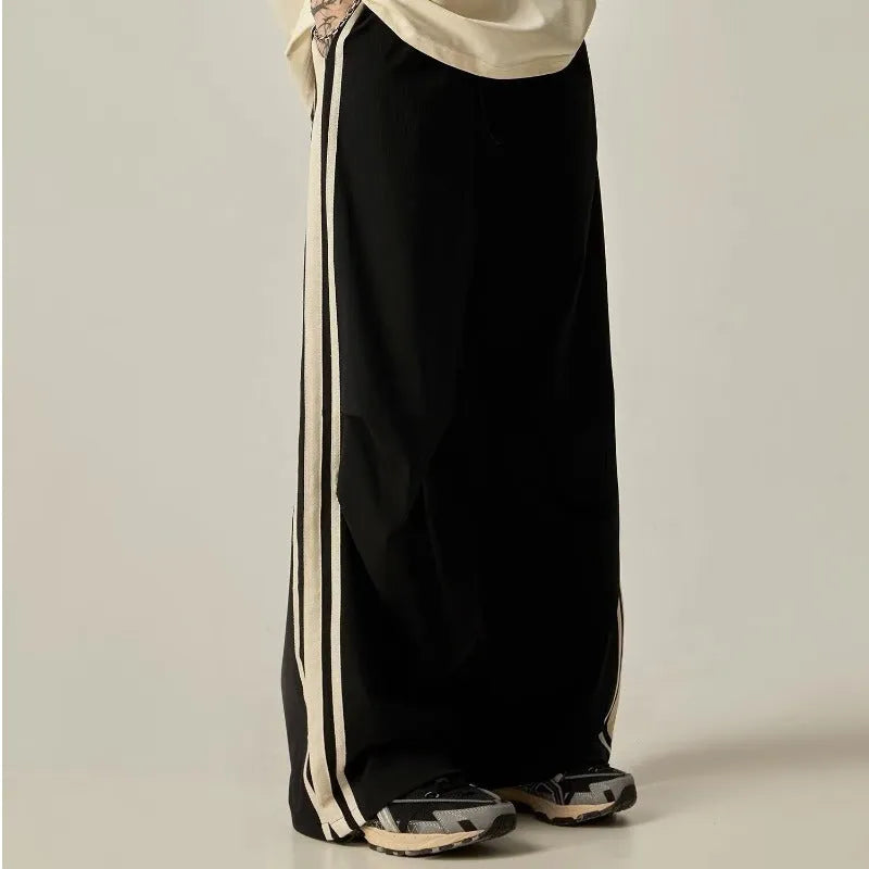 Black men's wide-leg high-waist climbing trousers laid flat, showing straight-leg cut.