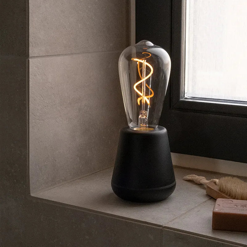 Portable LED camping lantern with aluminium body and 3-speed adjustable brightness in outdoor setting
