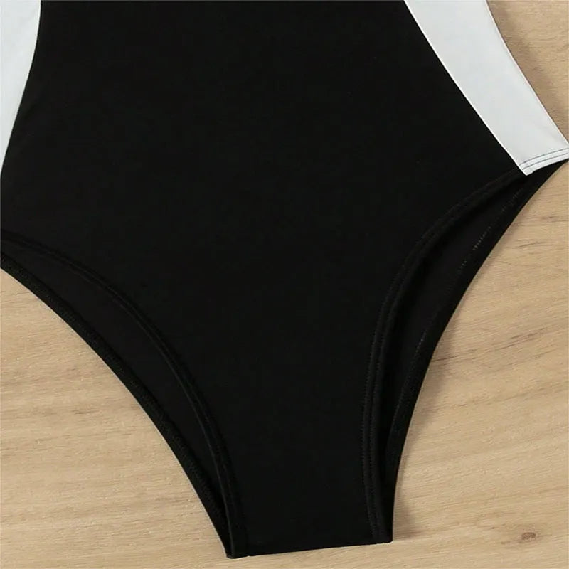 Black and white women's one-piece swimsuit with pearl spaghetti straps, slim fit for swimming.