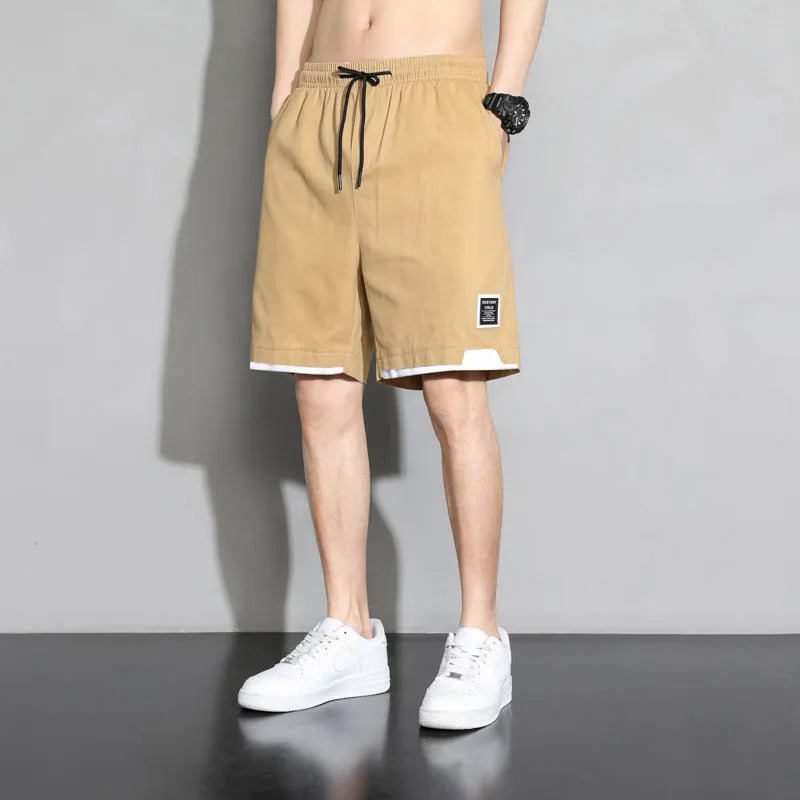 Boy wearing khaki cotton shorts with mid-waist, showing front view.