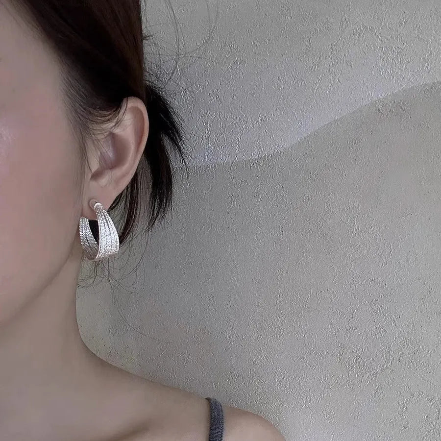 Geometric copper earrings with electroplated gold or silver finish showing stud and clip style options