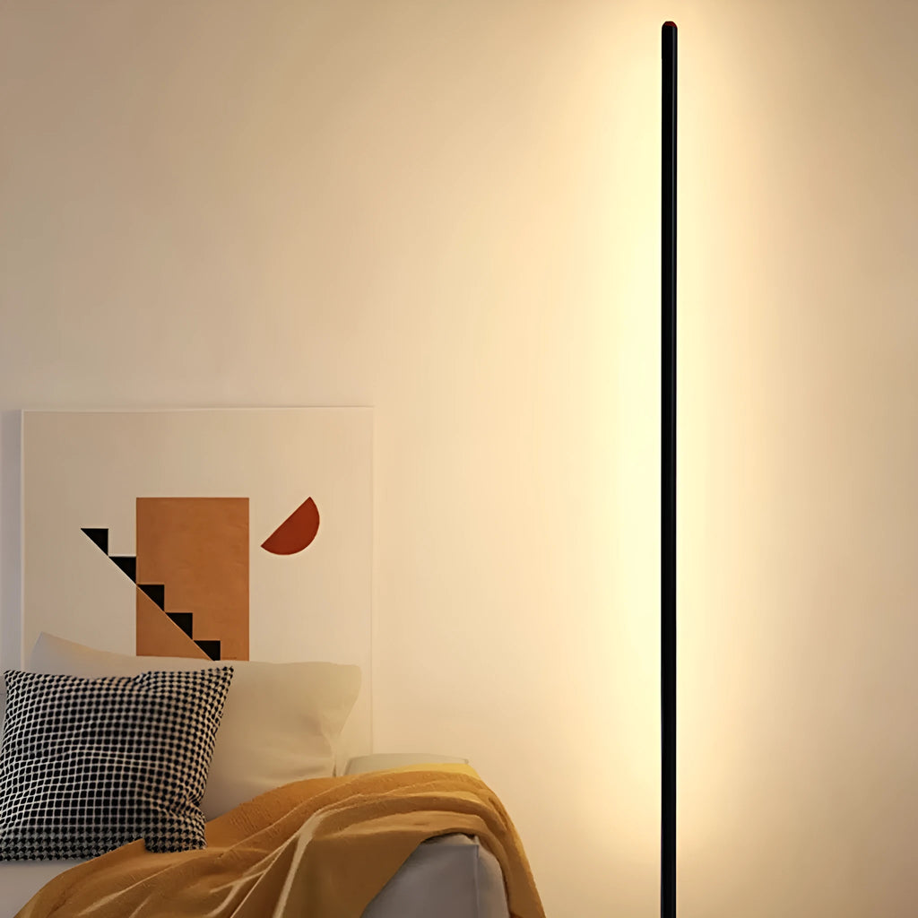 Slender vertical aluminium alloy LED floor lamp in a modern design next to a sofa.