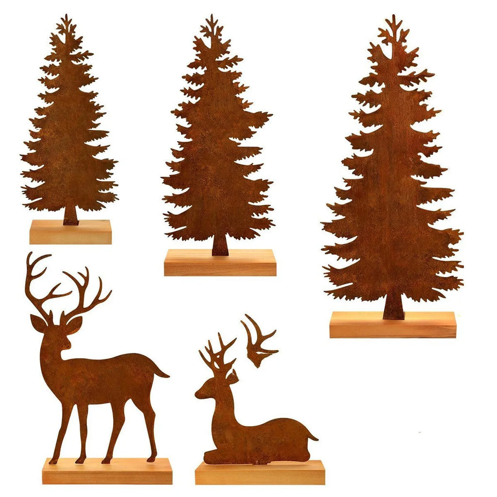 Set of three rustic iron metal Christmas tree and elk silhouette ornaments on a wooden surface.