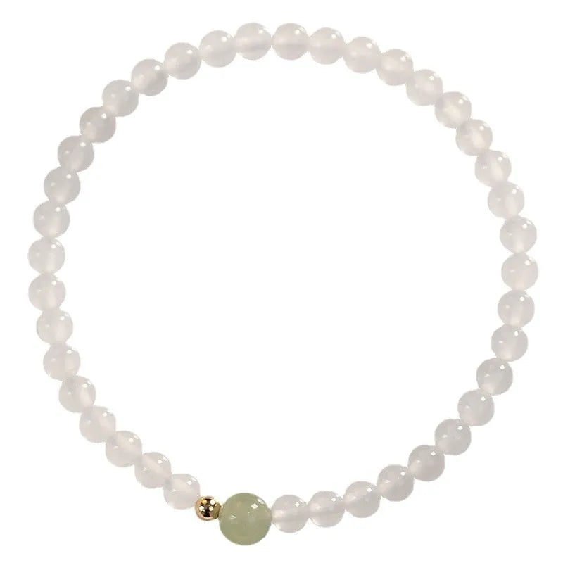 Close-up of a women's bracelet with white agate and Hetian jade beads on a 15 cm strand.