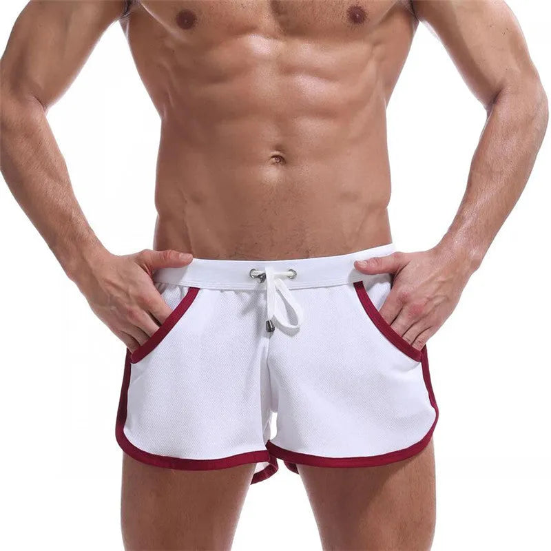 Summer men's quick-drying polyester beach sports shorts in green, with elastic waistband, front view