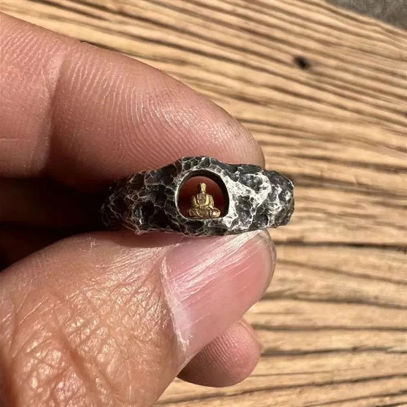 Hand-forged copper Buddha ring with grotto rock texture, shown on a size 8 finger.