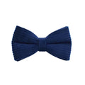 Navy blue corduroy dog collar and leash five-piece set with bow, vest, and poop bag on a wooden floor