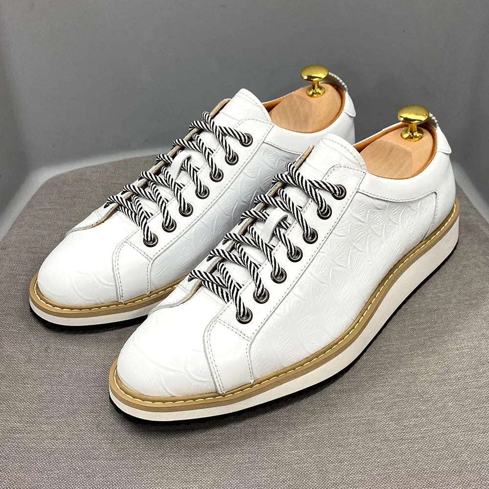 Men's low-top handmade shoes with embossed pattern detail on the upper and front lace closure.