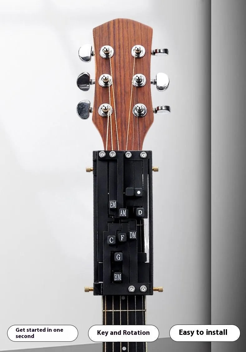 Black automatic chord practice device for novice guitar players attached to acoustic guitar