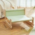 Wooden elevated cat bed with blue cloth hammock suspended inside frame