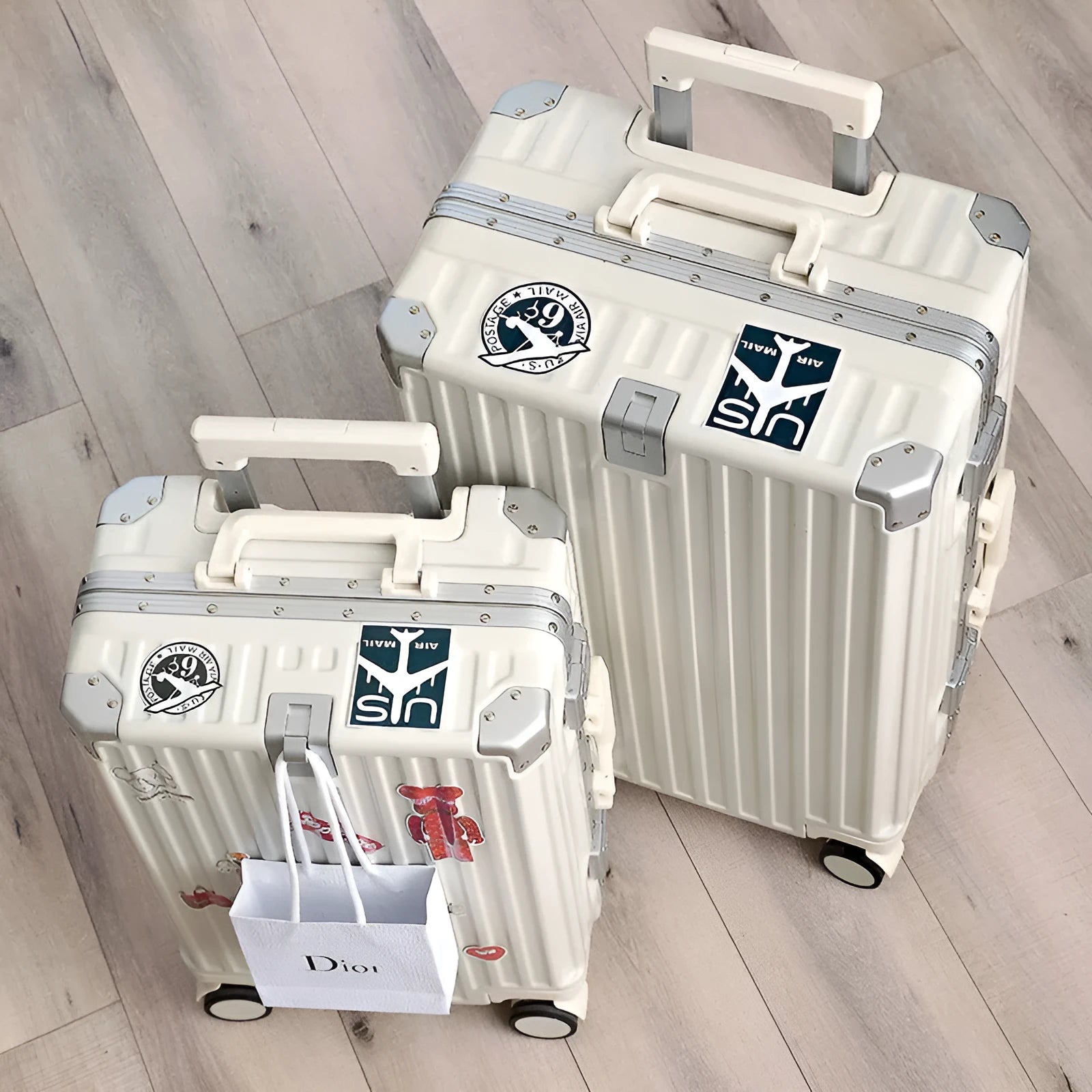 Aluminium frame travel luggage case in avocado green with universal wheels and a USB charging port.