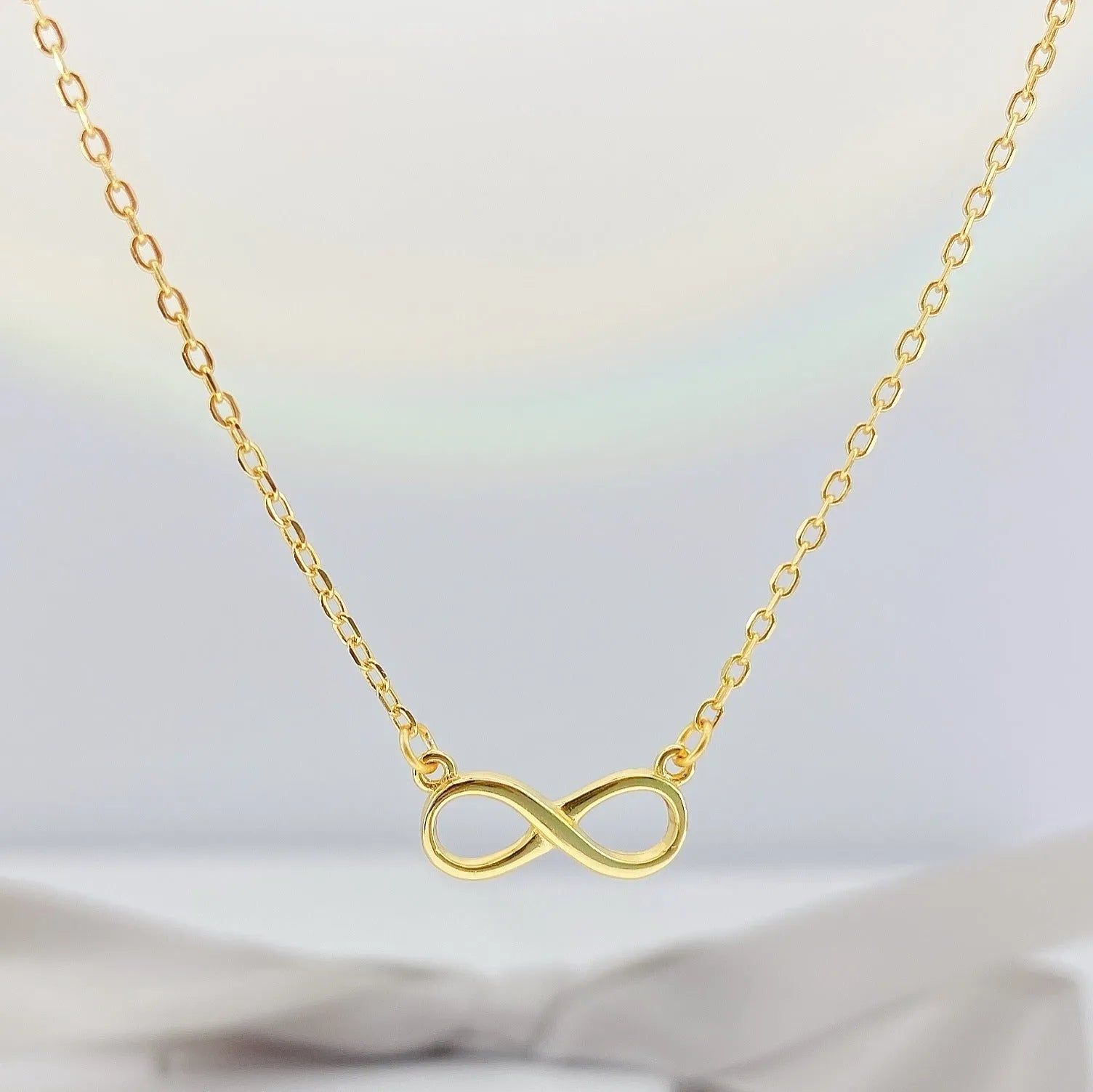 925 silver through-the-body pendant necklace with adjustable chain in platinum finish on collarbone