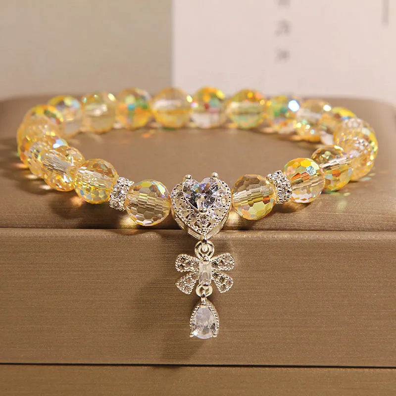 White crystal women's bracelet with butterfly and water drop charms on a metal chain, Japanese Korean style snowflake element.