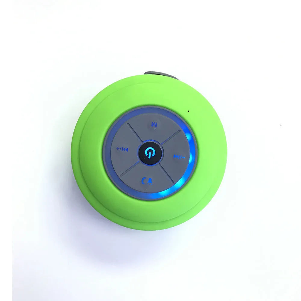 Waterproof suction cup Bluetooth speaker in black attached to a tiled wall