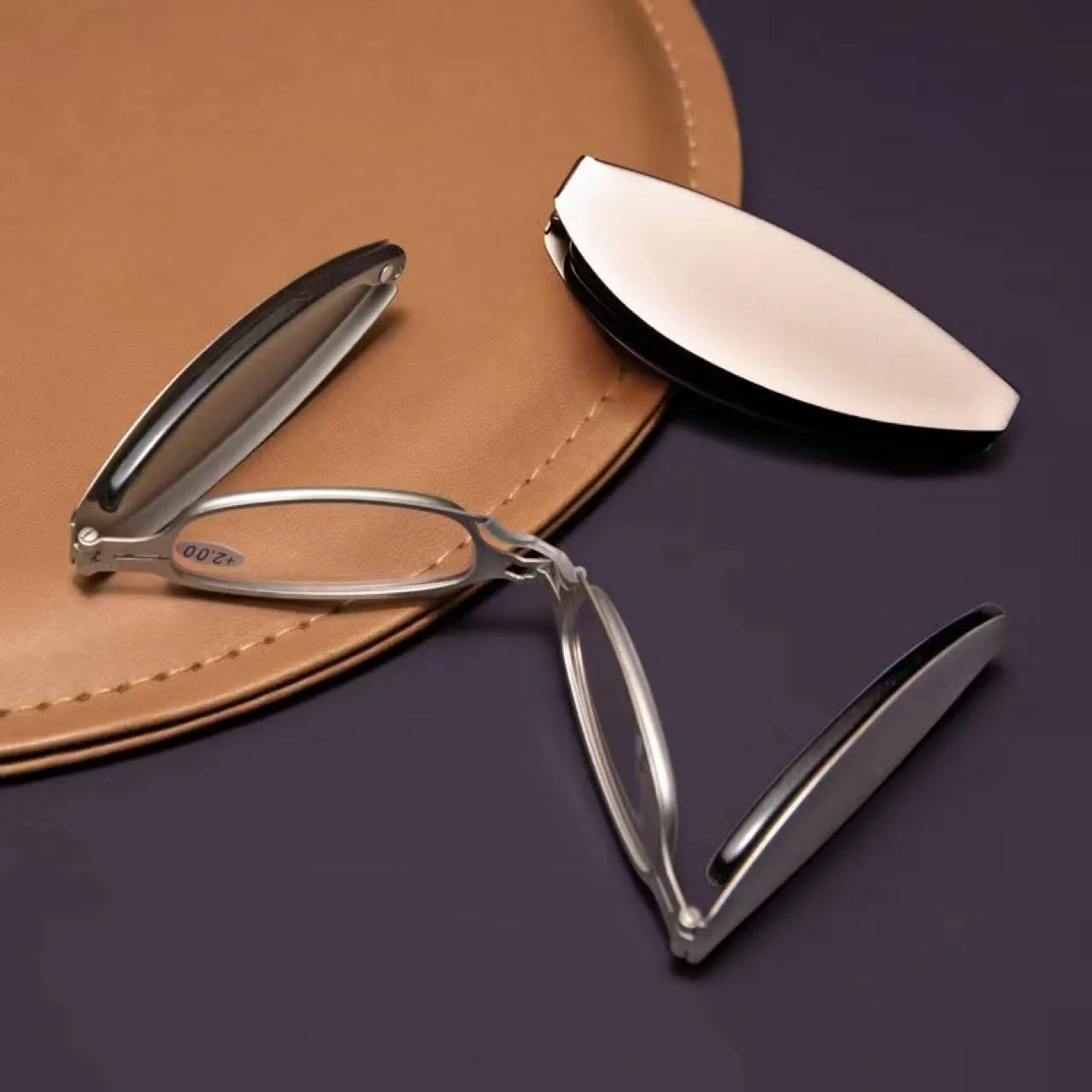 Black folding presbyopic glasses with retro ring-style frame, shown open and collapsed.