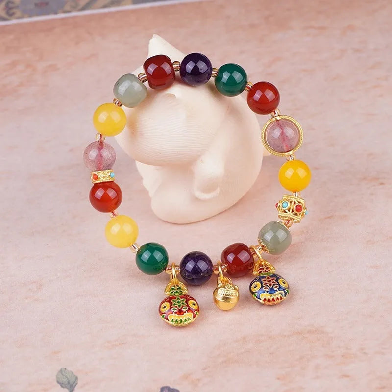 Hand-woven agate bracelet with 10mm swallowing gold beast beads on display