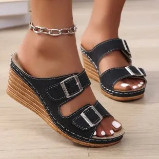 Women's creamy-white beach slippers with a wedge heel and decorative belt buckle on the upper.