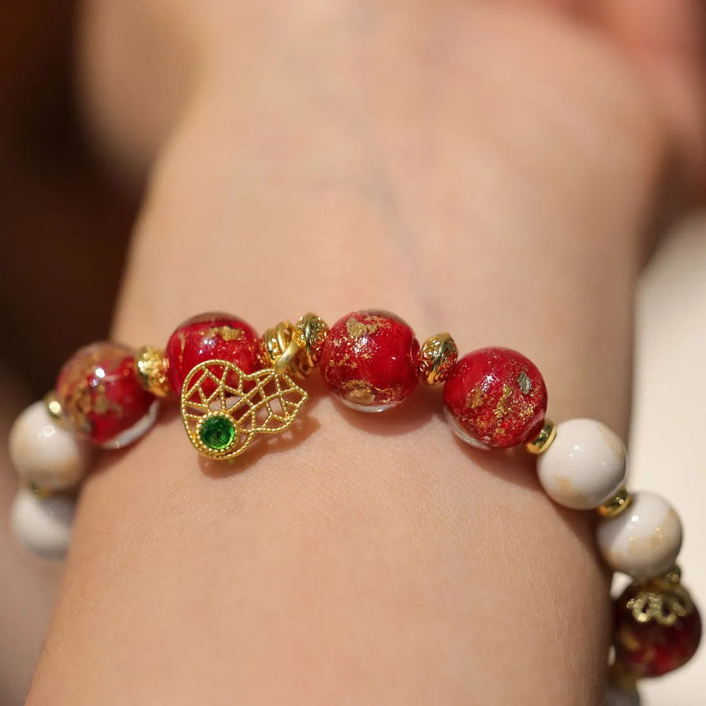 Gold foil coloured glaze ethnic bracelet with geometric Xingshi patterns and hanging gourd charms