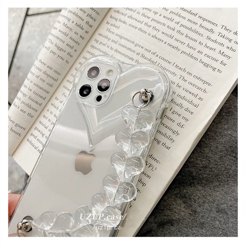 Clear iPhone case with a red love heart and chain design on the back
