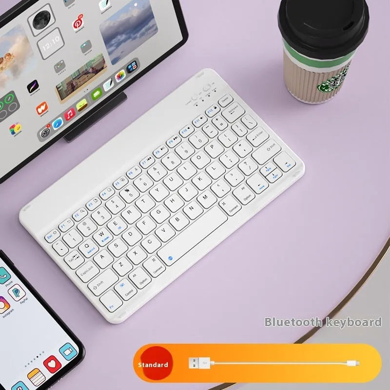 Bluetooth keyboard and matching rechargeable mouse set in elegant pink colour on a desk next to a tablet.