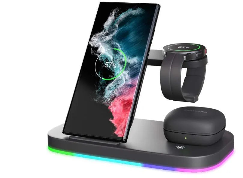 A vertical 3-in-1 wireless charging stand holding a mobile phone, a smartwatch, and headphones on a desk.