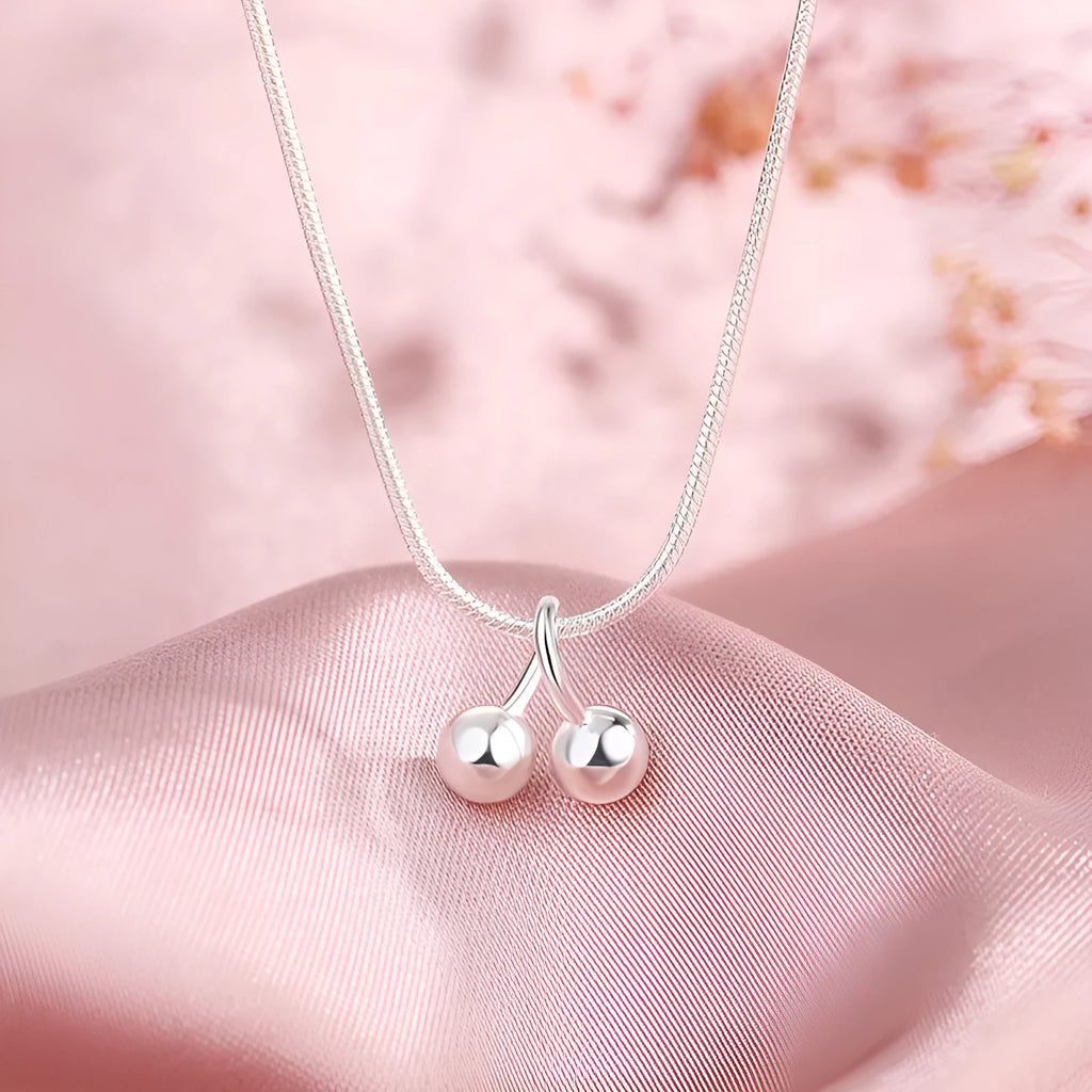 Silver cherry pendant necklace for women with adjustable snake chain.
