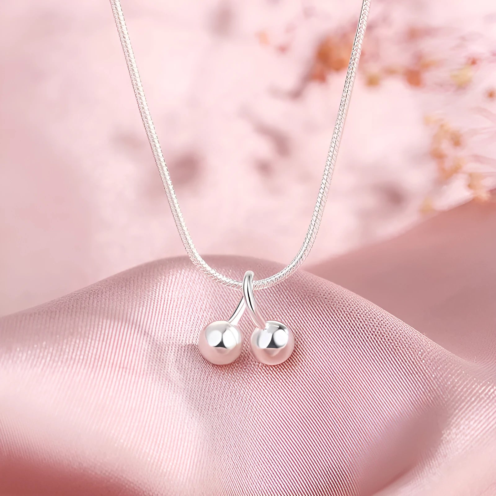 Silver cherry pendant necklace for women with adjustable snake chain.