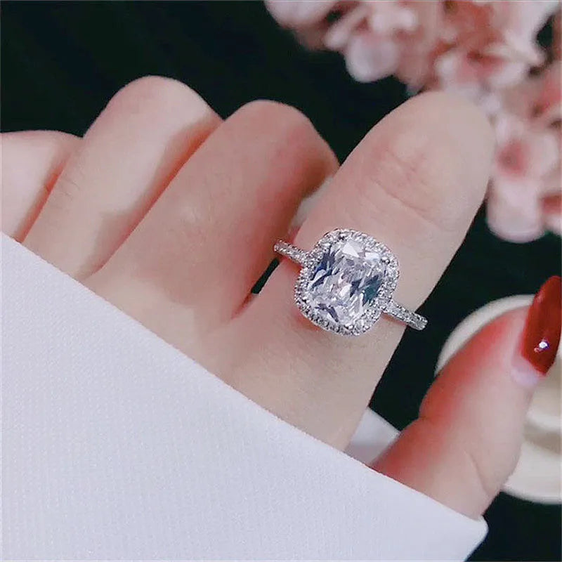 Silver alloy women's ring with artificial gemstone geometric design on white background