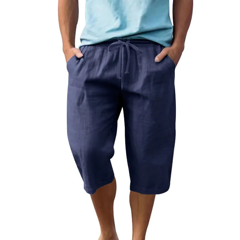 Men's solid colour linen shorts with a drawstring waist shown in a light blue shade.